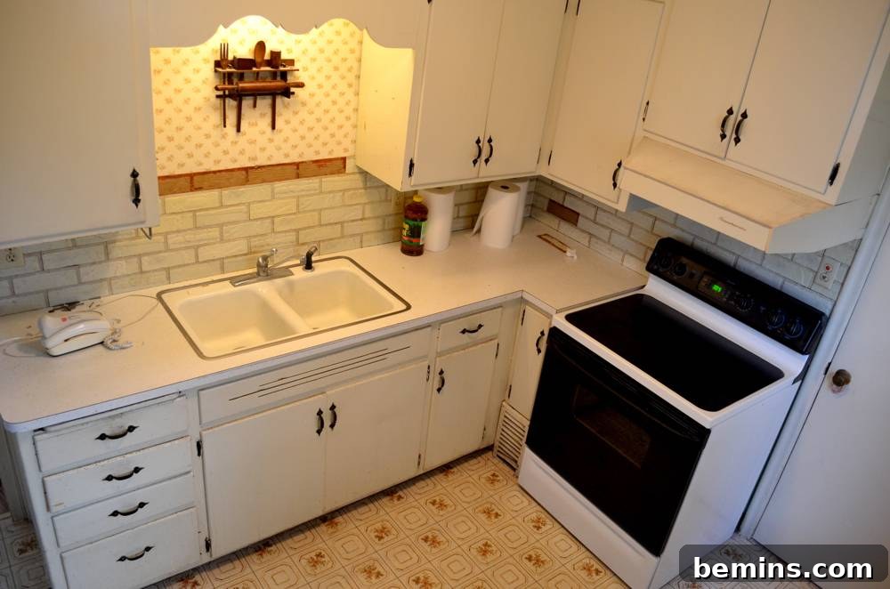 Before: The old, off-white cabinets and faux-brick backsplash.