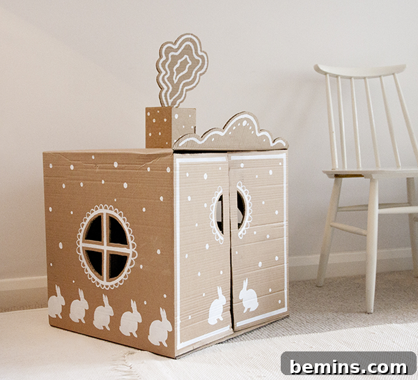 Cardboard Creations: 12 DIY Play Projects for Kids 12 A beautifully decorated pink cardboard playhouse with white bunnies.