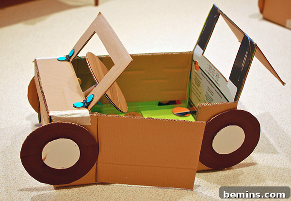 Cardboard Creations: 12 DIY Play Projects for Kids 4 A creatively designed cardboard car with brown tires, a green floorboard, and an inviting open door.