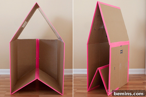 Cardboard Creations: 12 DIY Play Projects for Kids 6 A creatively designed collapsible cardboard playhouse adorned with pink tape.