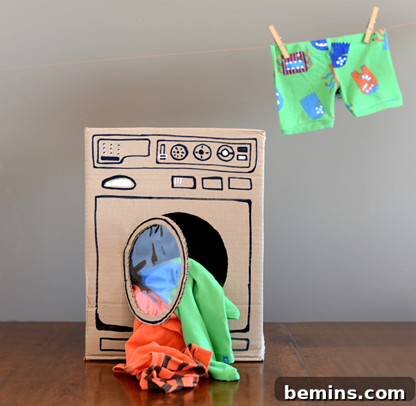 Cardboard Creations: 12 DIY Play Projects for Kids 7 A colorful cardboard washing machine filled with children's clothing.