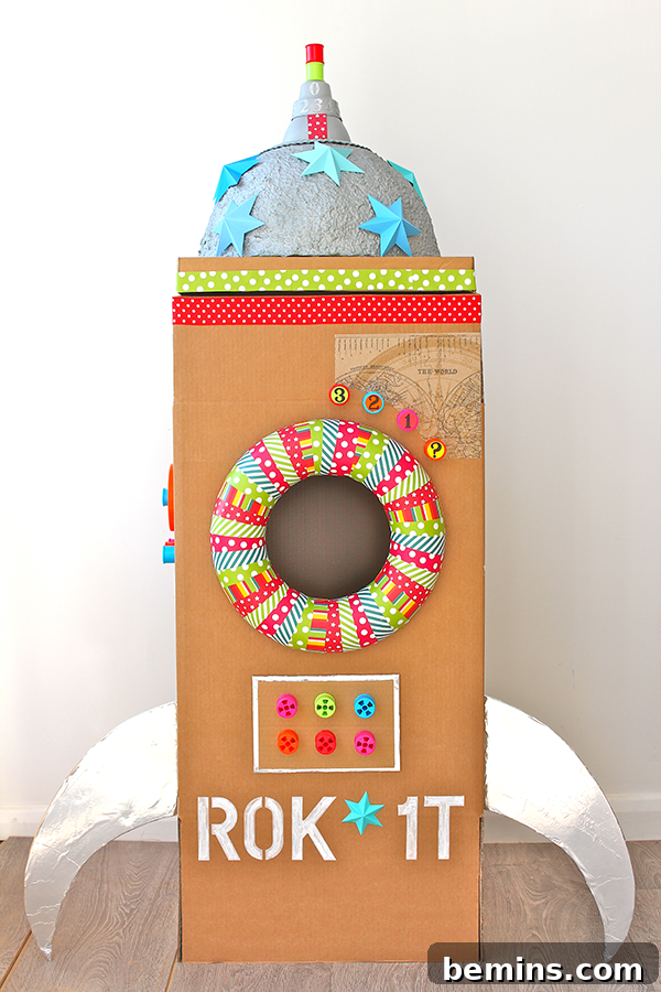 Cardboard Creations: 12 DIY Play Projects for Kids 8 A vibrantly decorated cardboard rocket ship with blue stars and colorful stripes.