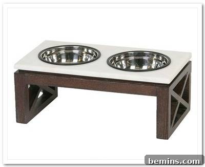 7 Chic Pet Bowls That Elevate Mealtime 9 A raised pet feeding bowl contains a food bowl and a water bowl and is made of wood with a white top.