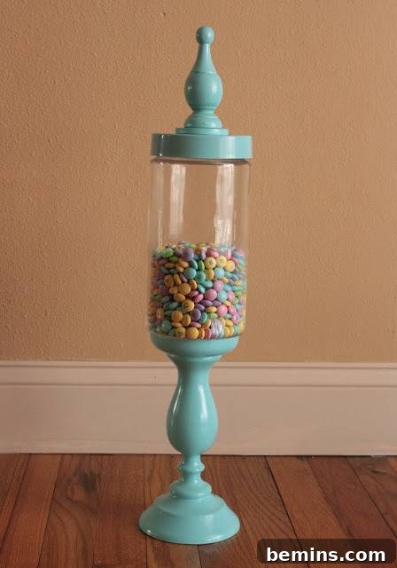 An ornate light blue glass stand filled with colorful candies.