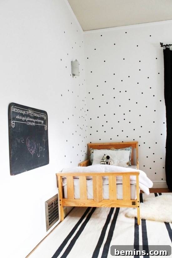 A striking black and white bedroom featuring a rustic wooden bed, blending modern and natural elements in a unique and stylish design.