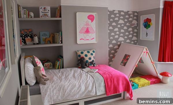 A bed is in a room decorated with a lot of pink.