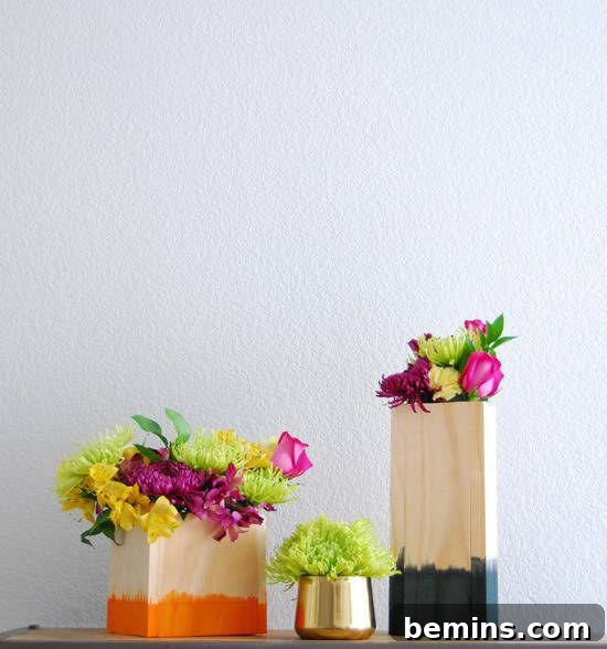 Wood blocks dyed to look like pots, with flowers in them.
