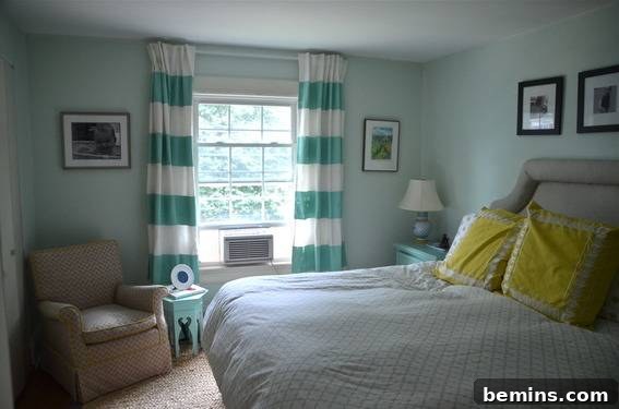 Painted Stripes: A Curtain Refresh 12 Teal walls with a window that has striped teal and white curtains in a bedroom, showcasing the finished DIY striped curtains in a stylish bedroom setting.