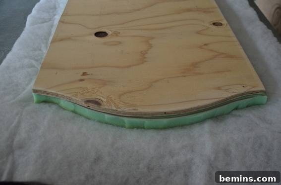 Wooden coffee table top being transformed into an ottoman with batting