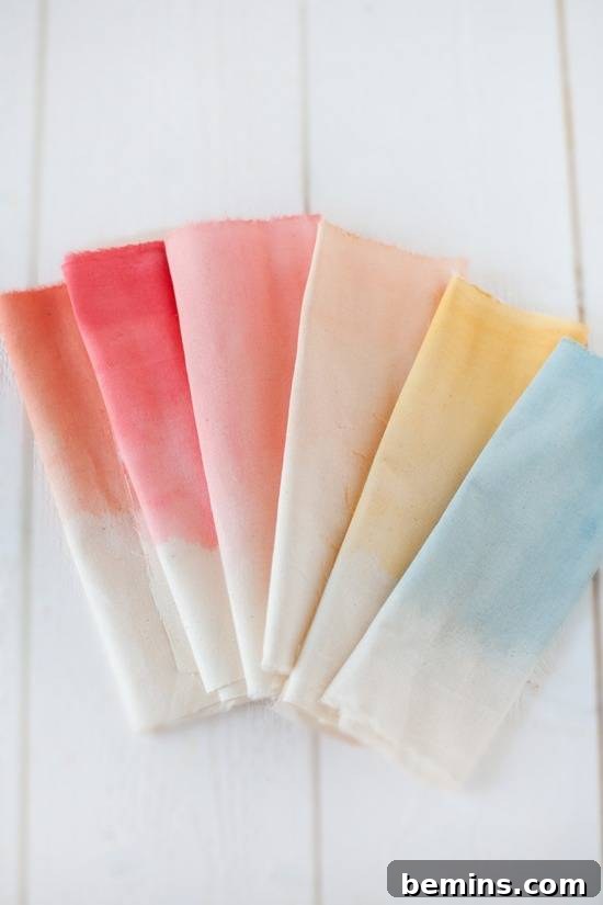 10 DIY Projects to Elevate Your Outdoor Dinner Party 3 Colorful tie-dye napkins folded and arranged on a white surface.