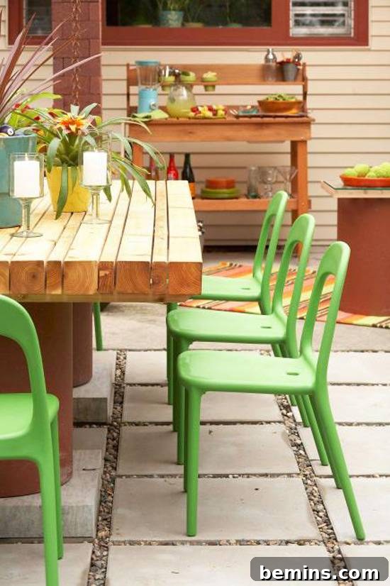 10 DIY Projects to Elevate Your Outdoor Dinner Party 6 Green painted chairs surrounding a wooden table on an outdoor patio.