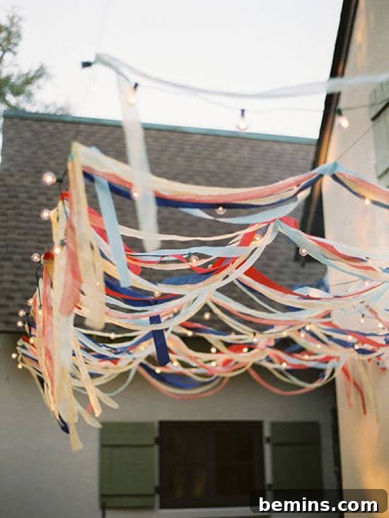 10 DIY Projects to Elevate Your Outdoor Dinner Party 8 Colorful ribbons hanging from cords, creating a streamer backdrop.