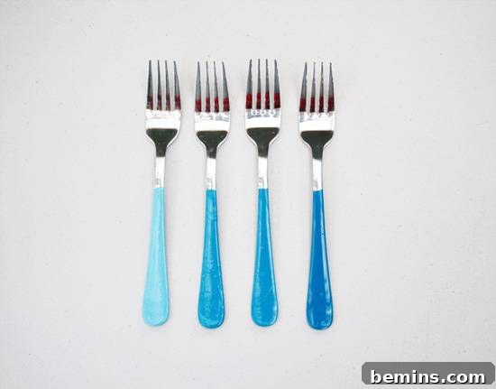 10 DIY Projects to Elevate Your Outdoor Dinner Party 10 Silverware forks with painted handles in varying shades of blue.