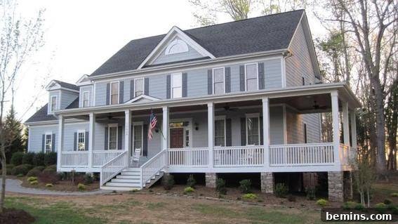 A large, colonial mansion bathed in soft gray light, highlighting the architectural details and the potential for a welcoming front porch addition