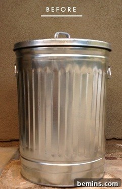 Brighten Up Your Bin: A Trash Can Transformation 2 A metal trashcan is sitting near a tan wall.