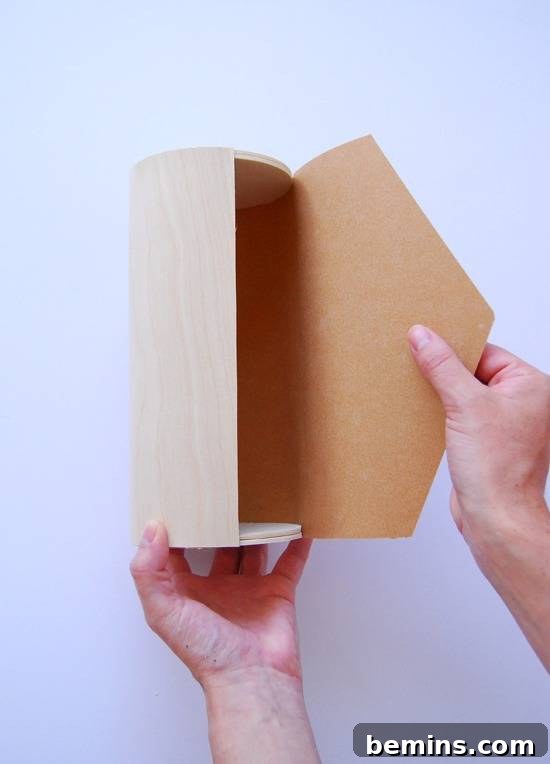 A person is holding a brown box.