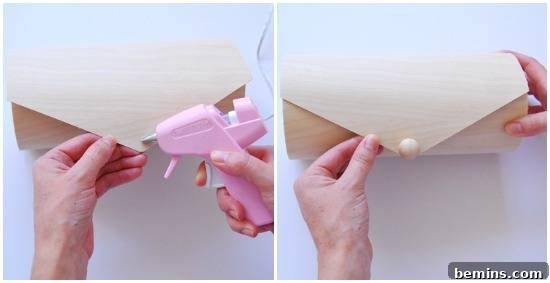 Person gluing a button of a wooden purse.