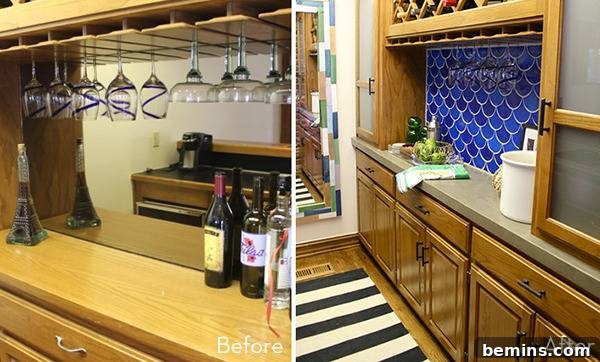 A kitchen area that has bottles of wine and glasses.