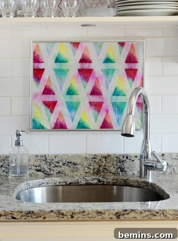 A colorful rag is hanging behind a sink.