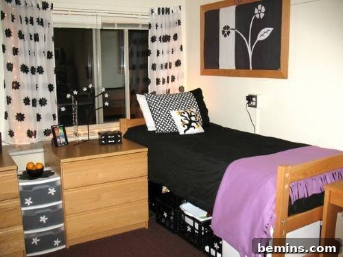 A bedroom featuring a black and pink bed, with an open window allowing natural light to fill the space.