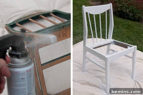 A chair is being spray painted white outside. Using primer before paint.
