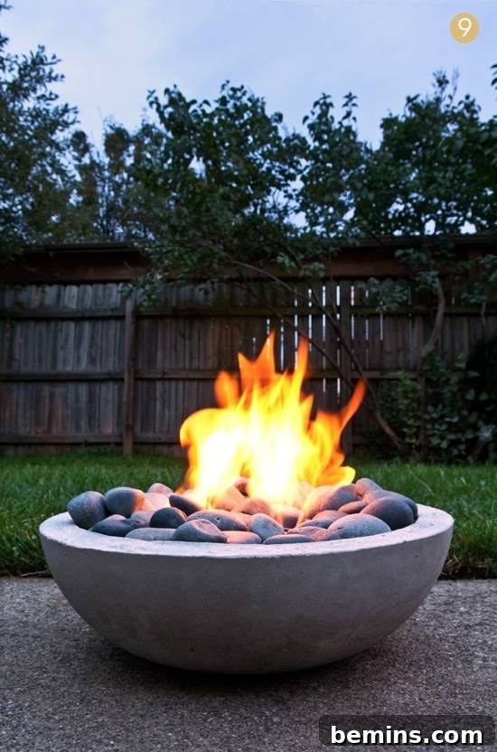 A small, modern fire pit nestled in a backyard setting, providing warmth and ambiance.