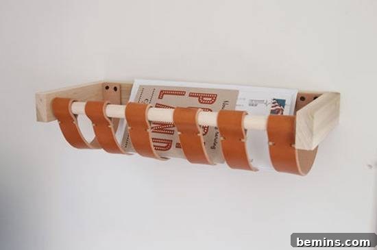 Leathercraft Dreams: 11 DIY Projects to Ignite Your Creativity 12 A floating shelf with orange leather straps holding a magasine.
