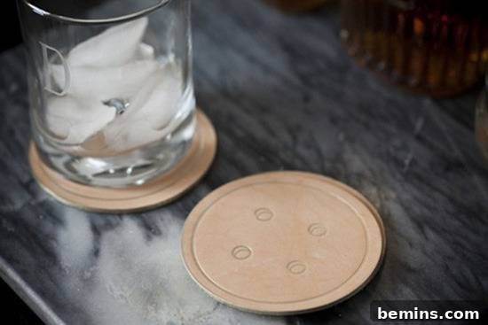 Leathercraft Dreams: 11 DIY Projects to Ignite Your Creativity 9 Two button coaster with a glass of ice water on it.
