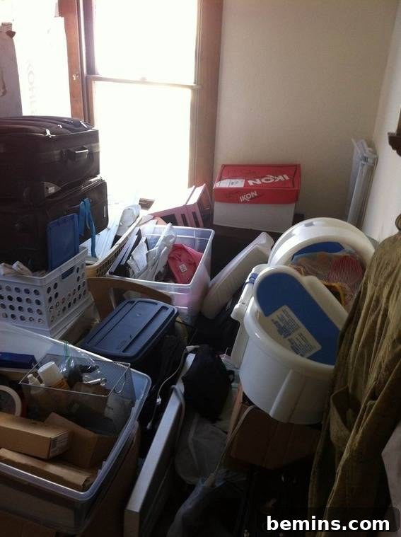 Baskets and bins piled on top of each other in a cluttered room, representing the 'before' state of the master bedroom.