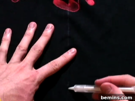 Drawing a line down the center of the t-shirt with a fabric pen.