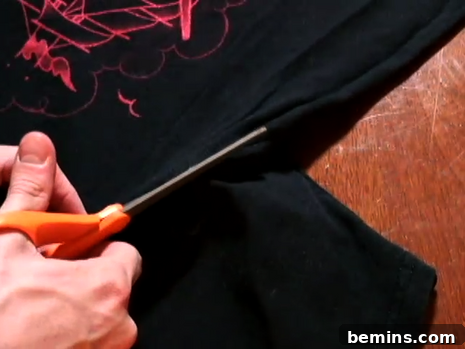 Cutting off the sleeves of the t-shirt.