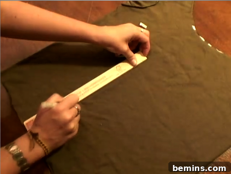 A woman measuring a brown piece of fabric.