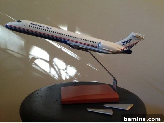 Close-up view of the model airplane on a black surface. Shows the damage sustained during the fall.