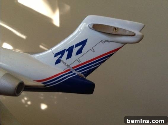 Detailed image of the damaged tail section of the model airplane. Focus on the broken stabilizers.