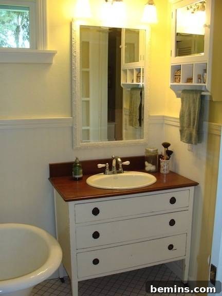 'A simple and Neatly Organized Bathroom with sinks and Tub', featuring a beautiful repurposed dresser vanity from An Oregon Cottage.