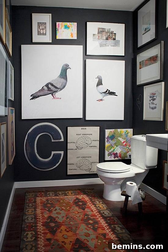 Dark Indulgence: 10 Bathrooms Embracing the Moody Palette 3 A chic dark bathroom featuring a gallery wall that adds visual interest and height.