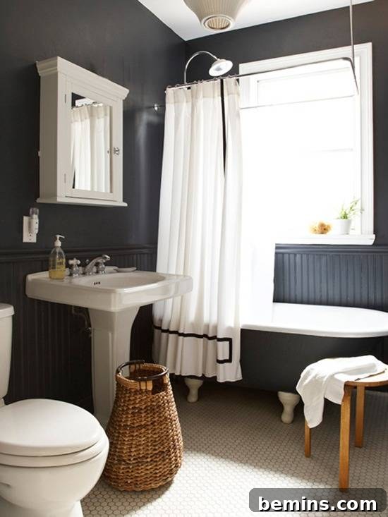 Dark Indulgence: 10 Bathrooms Embracing the Moody Palette 4 A modern black bathroom with crisp white fixtures, creating a striking contrast.