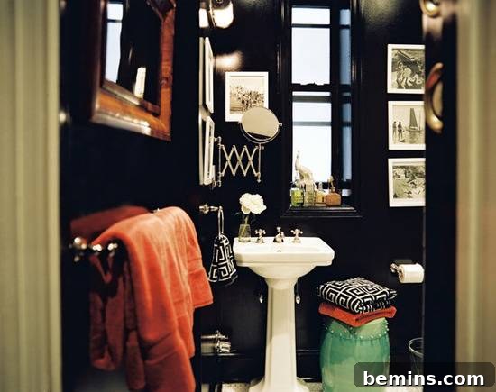 Dark Indulgence: 10 Bathrooms Embracing the Moody Palette 7 A small bathroom with dark blue walls that create a sense of depth and intimacy.