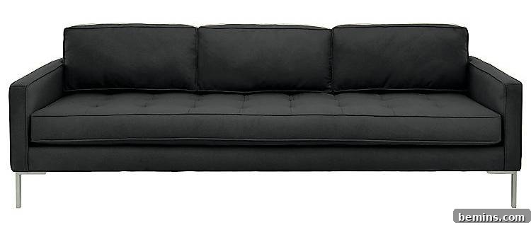 A long black couch with silver legs.