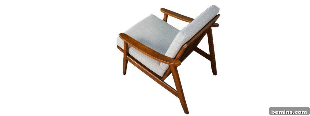 Wooden deck chair with fabric, cushioned pillows.
