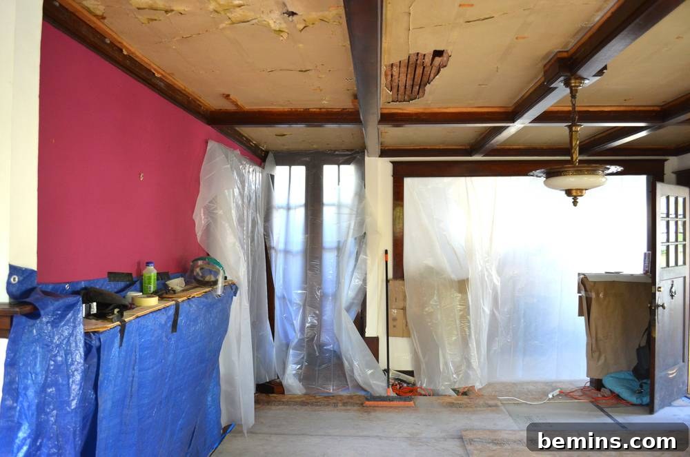 Gut renovation of a room with plastic sheeting on the walls.
