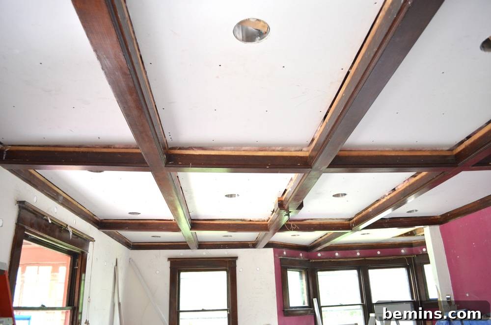 Exposed wood beams on a ceiling in a living room.