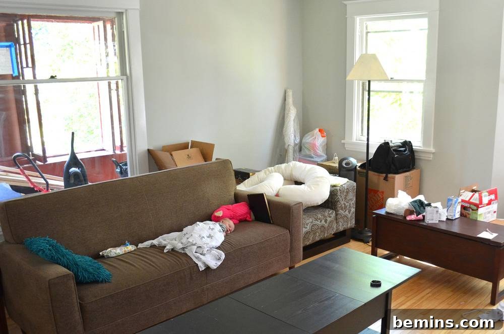 Living room with furniture strewn with clothing.
