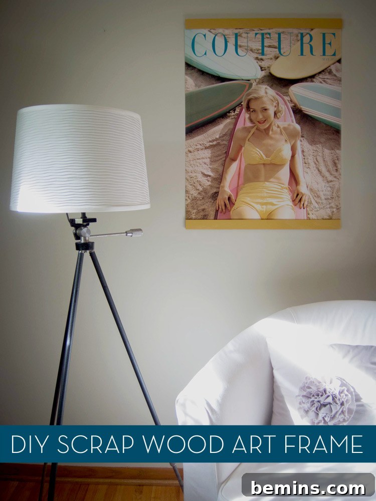 Handmade poster hanger crafted from reclaimed wood, mounted on a wall, illuminated by a bedside table lamp.