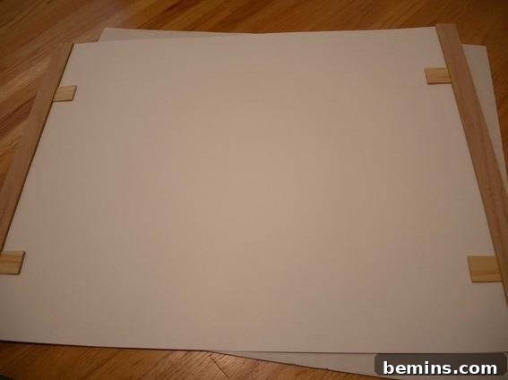 Close-up illustrating the process of using shims to secure the poster within the wooden slats of the DIY poster hanger.