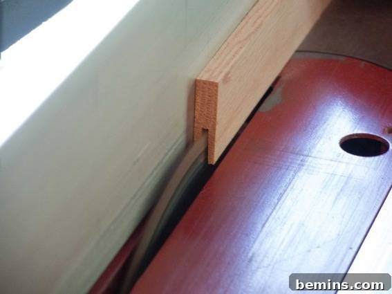 Detailed shot illustrating the process of creating a DIY poster hanger from reclaimed wood.