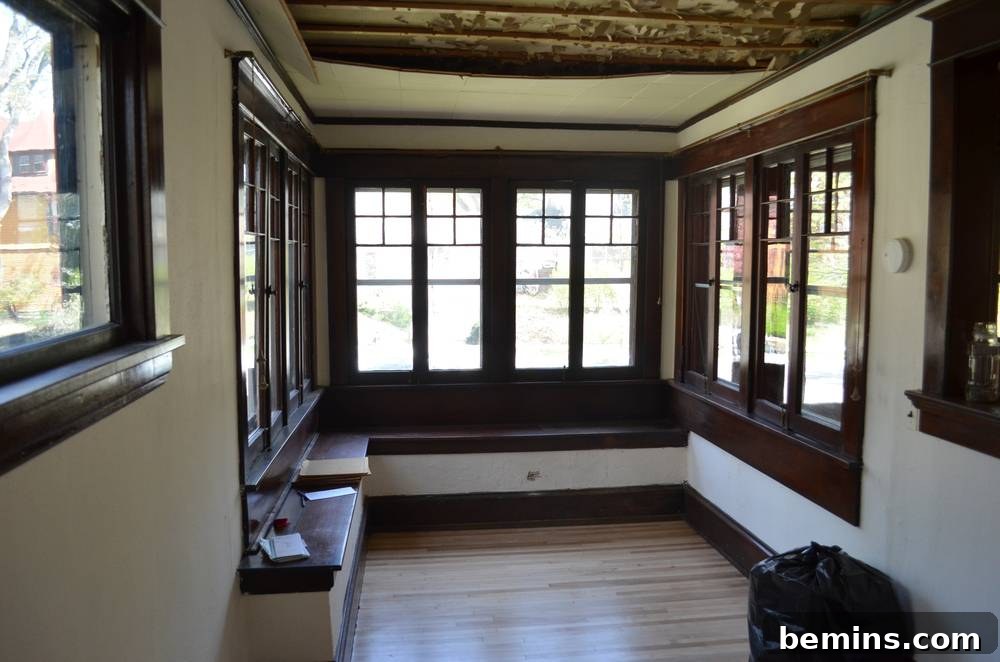 Original sunroom condition with damaged window frames.