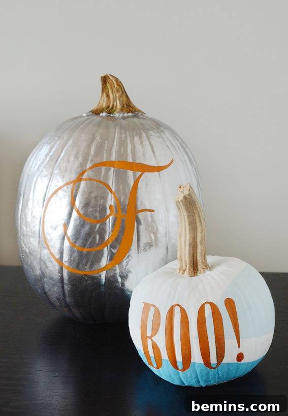 Silver painted pumpkin with cursive letter F next to Boo! painted pumpkin