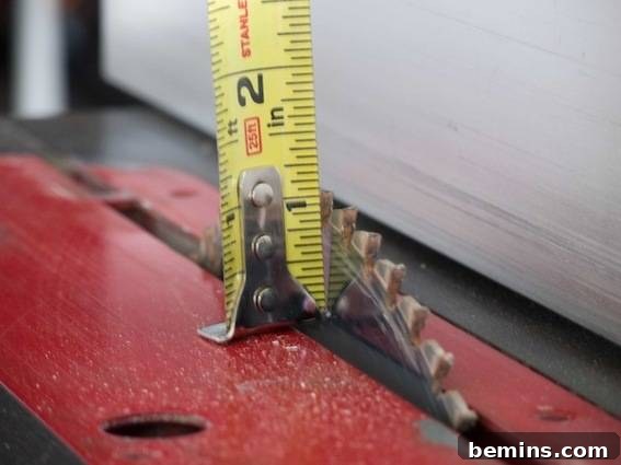 Craft a Rustic Chalkboard Card Display from Reclaimed Wood 7 A tape measurer is standing on the end of a saw blade. Measuring the saw blade height to ensure the correct depth for the card holder channel.