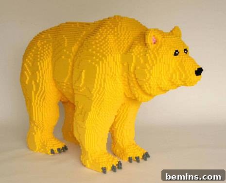 A yellow LEGO bear sculpture, representing childhood and innocence